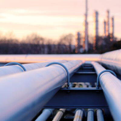 steel long pipe system in crude oil factory during sunset